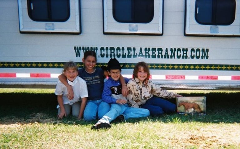 Happy summer campers ready for horseback riding adventure